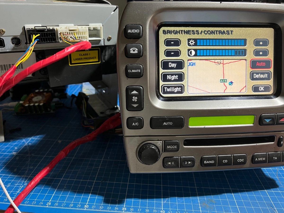 The sat nav retrofit loom connected on the bench to a Jaguar navigation unit and touchscreen